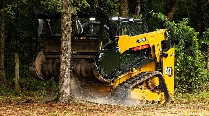 Forestry mulcher operating in a wooded area to process brush and vegetation