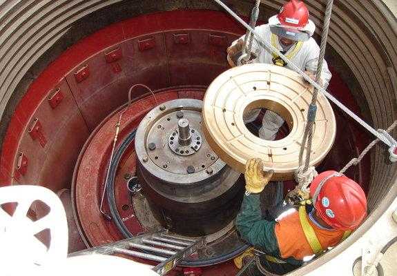 Technicians installing wear parts in mining equipment
