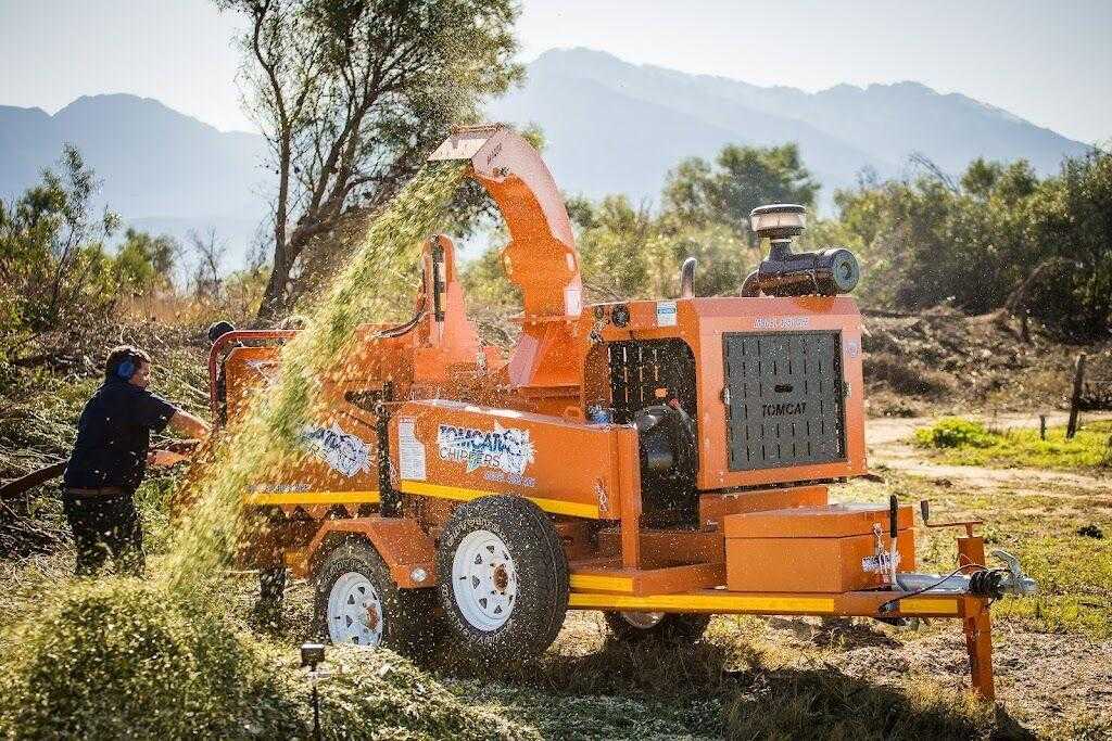 Chipper mulcher processing branches and wood debris