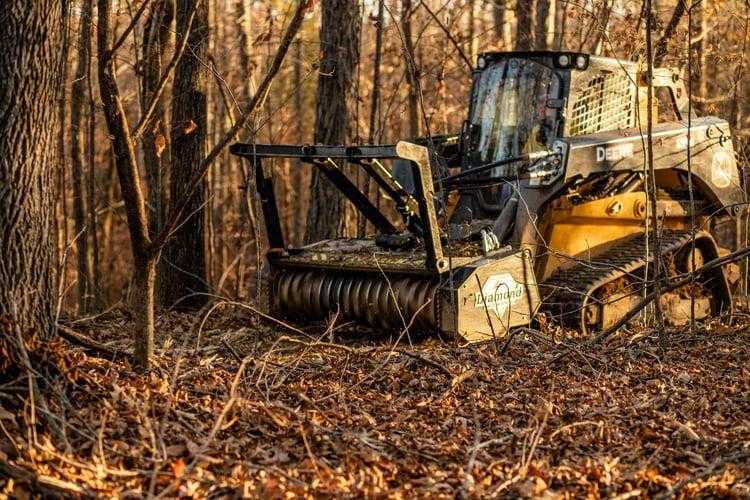 Drum mulcher grinding trees and brush for land clearing