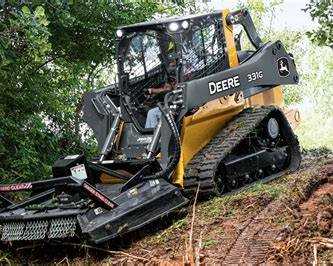 Rotary mulcher clearing vegetation and brush